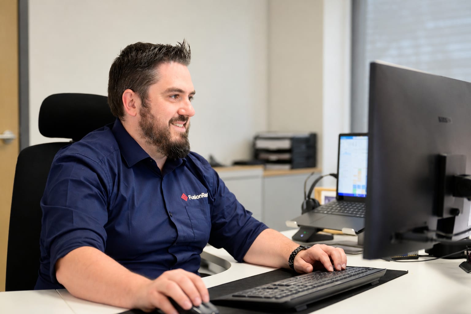 Daniel from the FusionRed team at work in the office