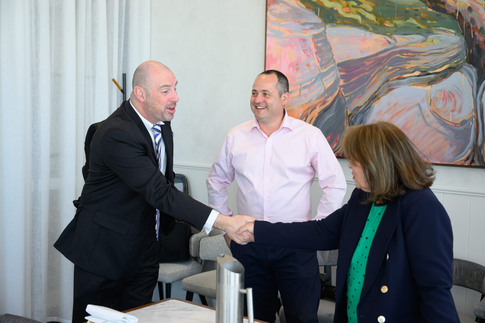 A FusionRed consultant shaking hands with a client